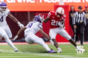 Nebraska Cornhusker running back Emmett Johnson (21) cuts back against Northwestern Wildcat defensive back Braden Turner (9) in the second quarter during a college football game on Saturday, October 25, 2025, in Lincoln, Nebraska. Photo by John S. Peterson.