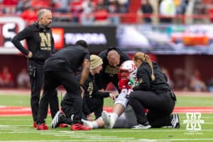 Nebraska Cornhusker offensive lineman Teddy Prochazka (65) is getting evaluated after an injury in the second quarter against the Northwestern Wildcats during a college football game on Saturday, October 25, 2025, in Lincoln, Nebraska. Photo by John S. Peterson.