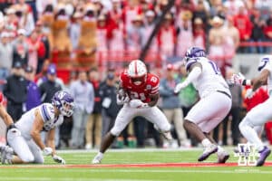 Nebraska Cornhusker running back Emmett Johnson (21) runs with the ball against Northwestern Wildcat defensive lineman Brendan Flakes (15) in the first quarter during a college football game on Saturday, October 25, 2025, in Lincoln, Nebraska. Photo by John S. Peterson.