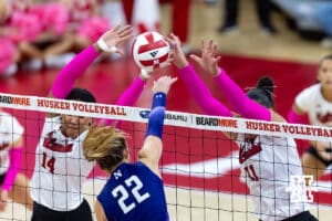Nebraska Cornhusker middle blocker Manaia Ogbechie (14) and outside hitter Teraya Sigler (11) block a spike from Northwestern Wildcat outside hitter Isabella Bullington (22) in the third set during a college volleyball match on Friday, October 24, 2025, in Lincoln, Nebraska. Photo by John S. Peterson.