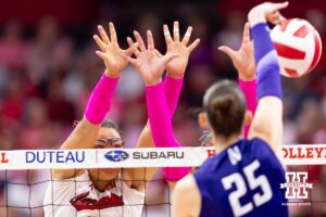 Nebraska Cornhusker middle blocker Rebekah Allick (5) and outside hitter Teraya Sigler (11) jump up to block Northwestern Wildcat outside hitter Campbell Paris (25) in the second set during a college volleyball match on Friday, October 24, 2025, in Lincoln, Nebraska. Photo by John S. Peterson.