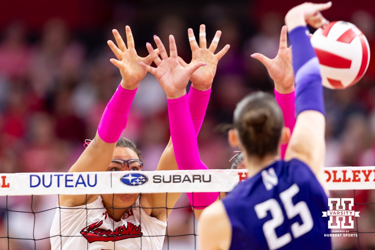 Nebraska Cornhusker middle blocker Rebekah Allick (5) and outside hitter Teraya Sigler (11) jump up to block Northwestern Wildcat outside hitter Campbell Paris (25) in the second set during a college volleyball match on Friday, October 24, 2025, in Lincoln, Nebraska. Photo by John S. Peterson.
