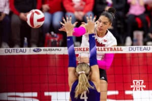 Nebraska Cornhusker outside hitter Teraya Sigler (11) spikes the ball against Northwestern Wildcat middle blocker Kayla Kauffman (4) in the second set during a college volleyball match on Friday, October 24, 2025, in Lincoln, Nebraska. Photo by John S. Peterson.