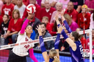 Nebraska Cornhusker outside hitter Taylor Landfair (12) spikes the ball against Northwestern Wildcat middle blocker Kayla Kauffman (4) and outside hitter Campbell Paris (25) in the first set during a college volleyball match on Friday, October 24, 2025, in Lincoln, Nebraska. Photo by John S. Peterson.