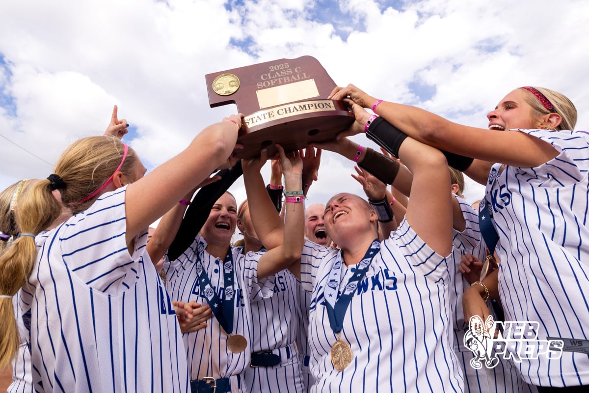 Hastings Saint Cecilila players holdup up the state championship trophy during a high school softball game, Monday, October 20, 2025, Lincoln, Nebraska. Photo by Braden Cochran.