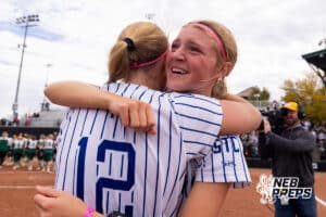 A Couple Bluejay teammates celebrate during a high school softball game, Monday, October 20, 2025, Lincoln, Nebraska. Photo by Braden Cochran.
