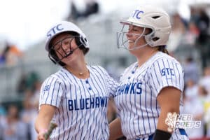 Hastings St. Cecilia teammates clebrates after a score during a high school softball game, Monday, October 20, 2025, Lincoln, Nebraska. Photo by Braden Cochran.