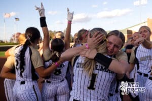Northwest infielder Becca Dinkelman (1) embraces with a teammate after a high school softball championship game, Monday, October 20, 2025, Lincoln, Nebraska. Photo by Braden Cochran.