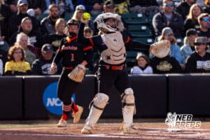 A Beatrice catcher warms up with pitcher Layla Boyko (11) in between innings during a high school softball championship game, Monday, October 20, 2025, Lincoln, Nebraska. Photo by Braden Cochran.