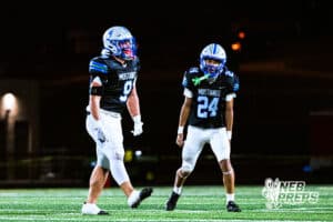Millard North's Zane Reynolds (9) and Devin Ray Jr (24) celebrate after a big stop on defense during a high school football game against Omaha Central on Friday, October 17, 2025, in Omaha, Nebraska. Photo By Jack Stephens.