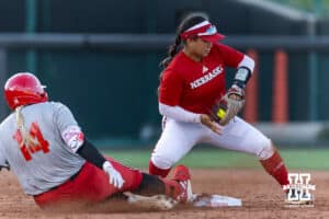 Nebraska Cornhusker Cream team Kacie Hoffmann (14) hits a double sliding into second against Nebraska Cornhusker Scarlet team Katelyn Caneda (66) during Nebraska Red/White Game on Wednesday, October 22, 2025, in Lincoln, Nebraska. Photo by John S. Peterson.