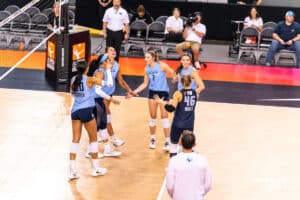 Team Hentz Sydney Hilley (#2) high fives her teammates as they celebrate a point together during the Athletes Unlimited Volleyball match against Team Hoffman on Monday, October 13, 2025, in Omaha, Nebraska. Photo by Dawson Anderson.