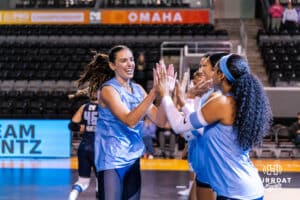 Team Hentz Sarah Parsons (#30) high fives teammate Kayla Caffey (#28) before the Athletes Unlimited Volleyball match against Team Hoffman on Monday, October 13, 2025, in Omaha, Nebraska. Photo by Dawson Anderson.
