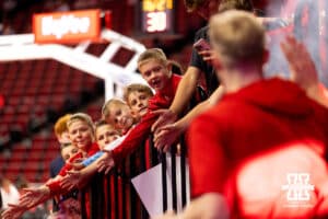 A group of young boys watches the Nebraska basketball team run out of the locker room for warmups during a college basketball game on Saturday, October 18th, 2025, in Lincoln, Nebraska. Photo by Braden Cochran.