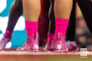 Nebraska Cornhuskers pink shoes with a ribbon and an ear of corn during a college football game against the Minnesota Golden Gophers on Friday, October 17, 2025, in Minneapolis, Minnesota. Photo by John S. Peterson.