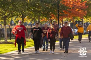Nebraska Cornhusker and Minnesota Golden Gopher fans make their way to the stadium for a college football game on Friday, October 17, 2025, in St. Paul, Minnesota. Photo by John S. Peterson.