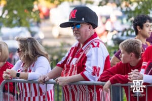 Nebraska Cornhuskers fan wear an oversized cap waiting for the team buses before the college football game against the Minnesota Golden Gophers on Friday, October 17, 2025, in Minneapolis, Minnesota. Photo by John S. Peterson.