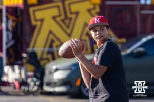 Nebraska Cornhusker fan throwing a football around at a tailgate during a college football game against the Minnesota Golden Gophers on Friday, October 17, 2025, in Minneapolis, Minnesota. Photo by John S. Peterson.