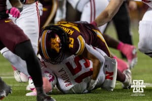 Nebraska Cornhusker quarterback Dylan Raiola (15) tackled by Minnesota Golden Gopher linebacker Matt Kingsbury (49) during a college football game on Friday, October 17, 2025, in Minneapolis, Minnesota. Photo by John S. Peterson.