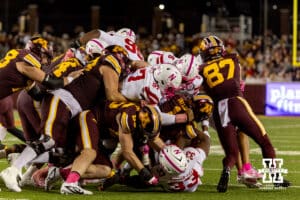 Nebraska Cornhusker linebacker Marques Watson-Trent (33), defensive lineman Keona Davis (97), and defensive back Deshon Singleton (8) tackle Minnesota Golden Gopher running back Darius Taylor (1) during a college football game on Friday, October 17, 2025, in Minneapolis, Minnesota. Photo by John S. Peterson.