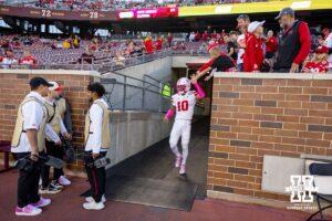 Nebraska Cornhusker defensive back Andrew Marshall (10) gives a high five to some fans before taking on the Minnesota Golden Gophers during a college football game on Friday, October 17, 2025, in Minneapolis, Minnesota. Photo by John S. Peterson.