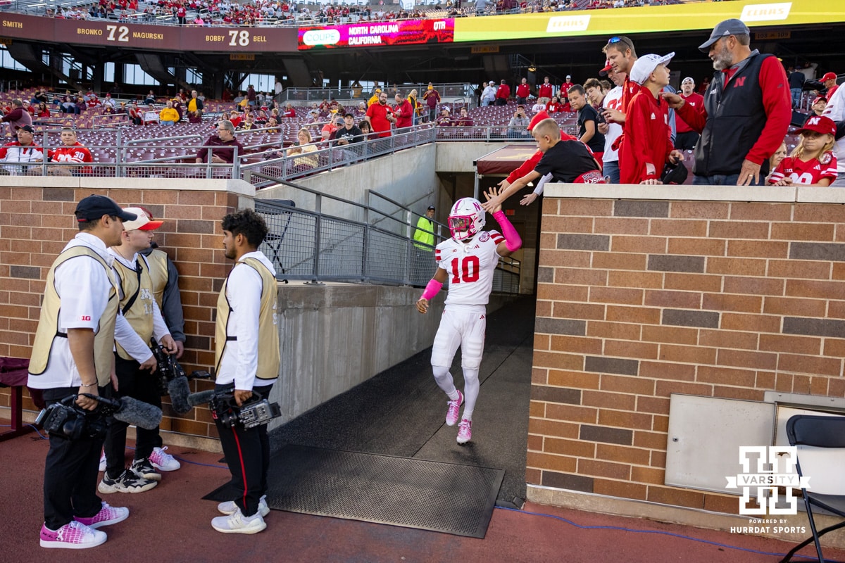 Nebraska Cornhusker defensive back Andrew Marshall (10) gives a high five to some fans before taking on the Minnesota Golden Gophers during a college football game on Friday, October 17, 2025, in Minneapolis, Minnesota. Photo by John S. Peterson.