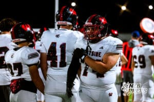 Westside's Luke Weiss (41) and Ahmad Rustamov (74) are celebrating after watching the team get a fumble recovery touchdown during a high school football game at Elkhorn South on Friday, October 10, 2025, in Omaha, Nebraska. Photo By Jack R. Stephens.