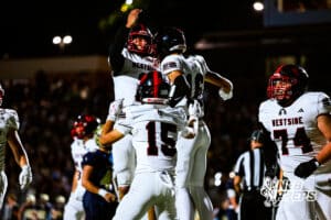 Westsides Braylen Warren (2), Andrew Tagge (15), and Mo Purify II (16) are celebrating after scoring a touchdown during a high school football game @ Elkhorn South on Friday, October 10, 2025, in Omaha, Nebraska. Photo By Jack R. Stephens.