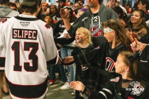 A young fan smiles at Omaha Maverick Jacob Slipec (13) after a college hockey game against Minnesota State on Friday, October 10, 2025, in Omaha, Nebraska. Photo by Dawson Anderson.