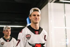 Omaha Maverick Griffin Ludtke (7) leads his team to celebrate with fans after winning a college hockey game against Minnesota State on Friday, October 10, 2025, in Omaha, Nebraska. Photo by Dawson Anderson.