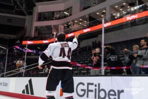 Omaha Maverick Spencer Sova (44) tosses a puck to a young fan after winning a college hockey game against Minnesota State on Friday, October 10, 2025, in Omaha, Nebraska. Photo by Dawson Anderson.