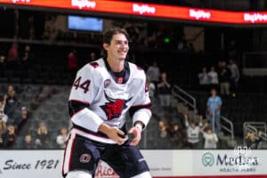 Omaha Maverick Spencer Sova (44) skates to give a fan a puck after winning a college hockey game against Minnesota State on Friday, October 10, 2025, in Omaha, Nebraska. Photo by Dawson Anderson.