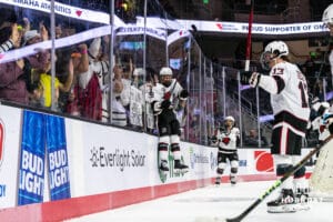 Omaha Maverick Marcus Broberg (22) leaps into the boards of the student section after winning a college hockey game against Minnesota State on Friday, October 10, 2025, in Omaha, Nebraska. Photo by Dawson Anderson.