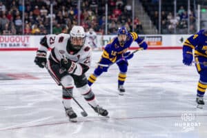 Omaha Maverick Tyler Rollwagen (21) beats out Minnesota State Maverick Alex Zetterberg (12), chasing a puck down the ice during a college hockey game Friday, October 10, 2025, in Omaha, Nebraska. Photo by Dawson Anderson.