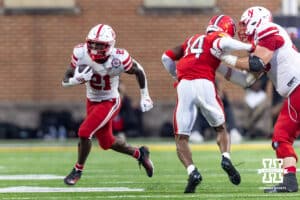 Nebraska Cornhusker running back Emmett Johnson (21) runs to the outside with the ball against Maryland Terrapin defensive back Jamare Glasker (14) during a college football game on Saturday, October 11, 2025, in College Park, MD. Photo by John S. Peterson.