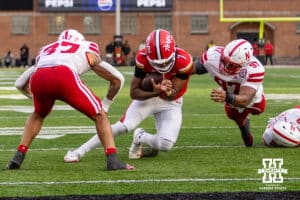 Nebraska Cornhusker defensive back Donovan Jones (37) and defensive lineman Keona Davis (97) tackles Maryland Terrapin quarterback Malik Washington (7)during a college football game on Saturday, October 11, 2025, in College Park, MD. Photo by John S. Peterson.