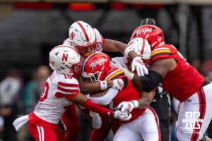 Nebraska Cornhusker defensive back Andrew Marshall (10), defensive back Deshon Singleton (8), and linebacker Javin Wright (0) tackle Maryland Terrapin running back Nolan Ray (2) in the first quarter during a college football game on Saturday, October 11, 2025, in College Park, MD. Photo by John S. Peterson.