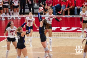 Nebraska Cornhusker Andi Jackson (#15) blocks a hit during a college volleyball match against Washington on Friday, October 10, 2025, in Lincoln, Nebraska. Photo by Brandon Tiedemann.
