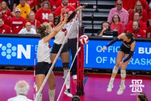 Nebraska Cornhusker Taylor Landfair (#12) blocks a hit during a college volleyball match against Washington on Friday, October 10, 2025, in Lincoln, Nebraska. Photo by Brandon Tiedemann.