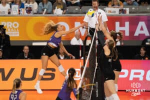 Team Hoffman Brooke Nuneviller (#50) hits the ball over defenders during the Athletes Unlimited Volleyball match against Team Thompson on Thursday, October 9, 2025, in Omaha, Nebraska. Photo by Brandon Tiedemann.