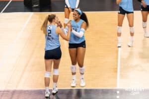 Team Hentz Sydney Hilley (#2) and Kayla Caffey (#28) smile at one another during the Athletes Unlimited Volleyball match against Team Valentin-Anderson on Thursday, October 9, 2025, in Omaha, Nebraska. Photo by Brandon Tiedemann.