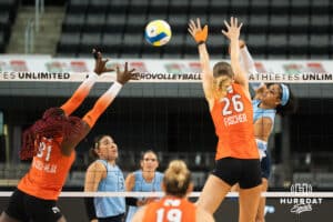 Team Hentz Kayla Caffey (#28) spikes it between defenders during the Athletes Unlimited Volleyball match against Team Valentin-Anderson on Thursday, October 9, 2025, in Omaha, Nebraska. Photo by Brandon Tiedemann.