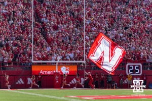 Nebraska Cornhuskers Spirit Squad running the flag in the endazone afte a touchdown against the Michigan State Spartans during a college football game on Saturday, October 4, 2025, in Lincoln, Nebraska. Photo by John S. Peterson.