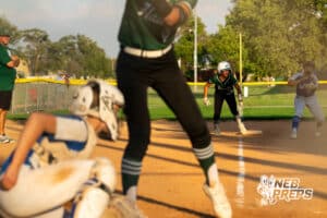 A Lincoln Southwest base runner prepares to run to home plate at a moments notice during a High School Volleyball game, Thursday, October 2nd, 2025, Lincoln, Nebraska. Photo by Braden Cochran.