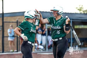 Lincoln Southwest's Taylor Siefken (12) and Ashley Jucht (16) celebrate after scoring a run during a high school softball game at Elkhorn South on Monday, September 29, 2025, in Omaha, Nebraska. Photo By Jack Stephens.