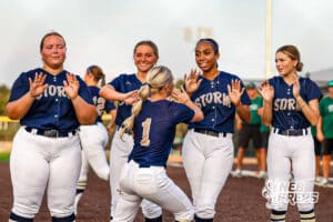 Elkhorn South's Hayden Peters (1) is giving high-fives to the line during pregame before a high school softball game VS Lincoln Southwest on Monday, September 29, 2025, in Omaha, Nebraska. Photo By Jack Stephens.