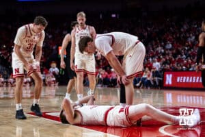 Nebraska Cornhusker guard Connor Essegian (0) takes a hard fall against the Winthrop Eagles in the second half as his teammates check him out during a college basketball game on Tuesday, Nov. 25, 2025, in Lincoln, Nebraska. Photo by John S. Peterson.