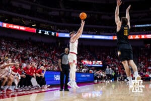 Nebraska Cornhusker guard Connor Essegian (0) makes a three-point shot against Winthrop Eagle guard Kody Clouet (11) in the second half during a college basketball game on Tuesday, Nov. 25, 2025, in Lincoln, Nebraska. Photo by John S. Peterson.