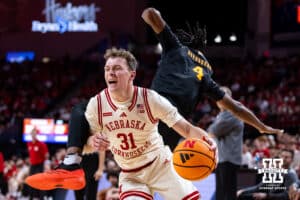 Winthrop Eagle forward Pharell Boyogueno (4) crashes down on Nebraska Cornhusker guard Cale Jacobsen (31) in the first half during a college basketball game on Tuesday, Nov. 25, 2025, in Lincoln, Nebraska. Photo by John S. Peterson.