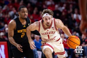 Nebraska Cornhusker guard Sam Hoiberg (1) dribbles the ball against Winthrop Eagle guard Kareem Rozier (2) in the first half during a college basketball game on Tuesday, Nov. 25, 2025, in Lincoln, Nebraska. Photo by John S. Peterson.